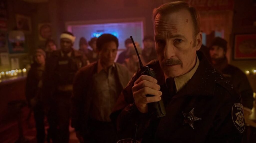 Normal movie still featuring Bob Odenkirk as an armed sheriff