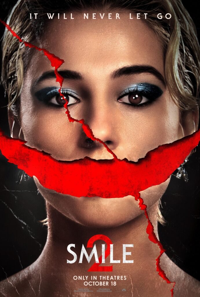 Smile 2 horror poster featuring a woman with a red crack across her face